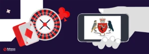 Ilse of Man Lizenz Logo auf einem Smartphone neben einem Roulettekessel und zwei Spielkarten